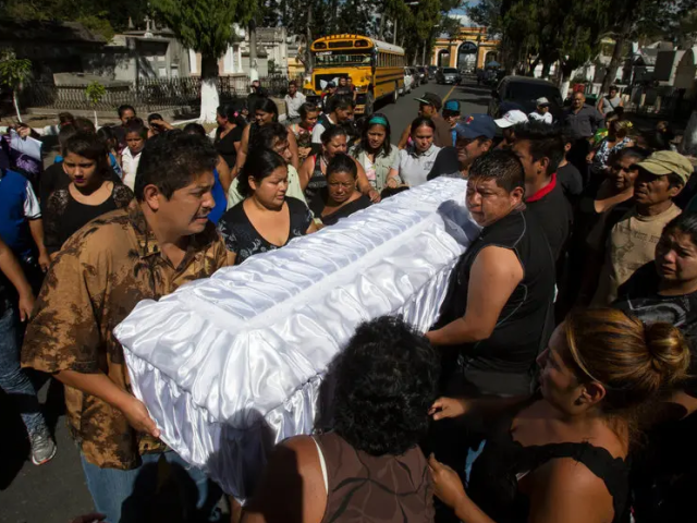 Family carrying casket