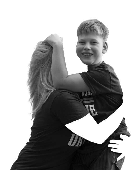 black and white image of a woman hugging a young boy, the womans face and arms are cut out of the picture