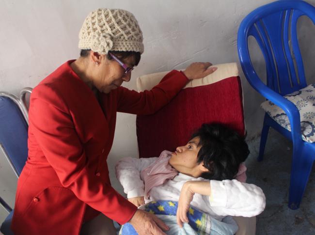 Woman in red with disabled child